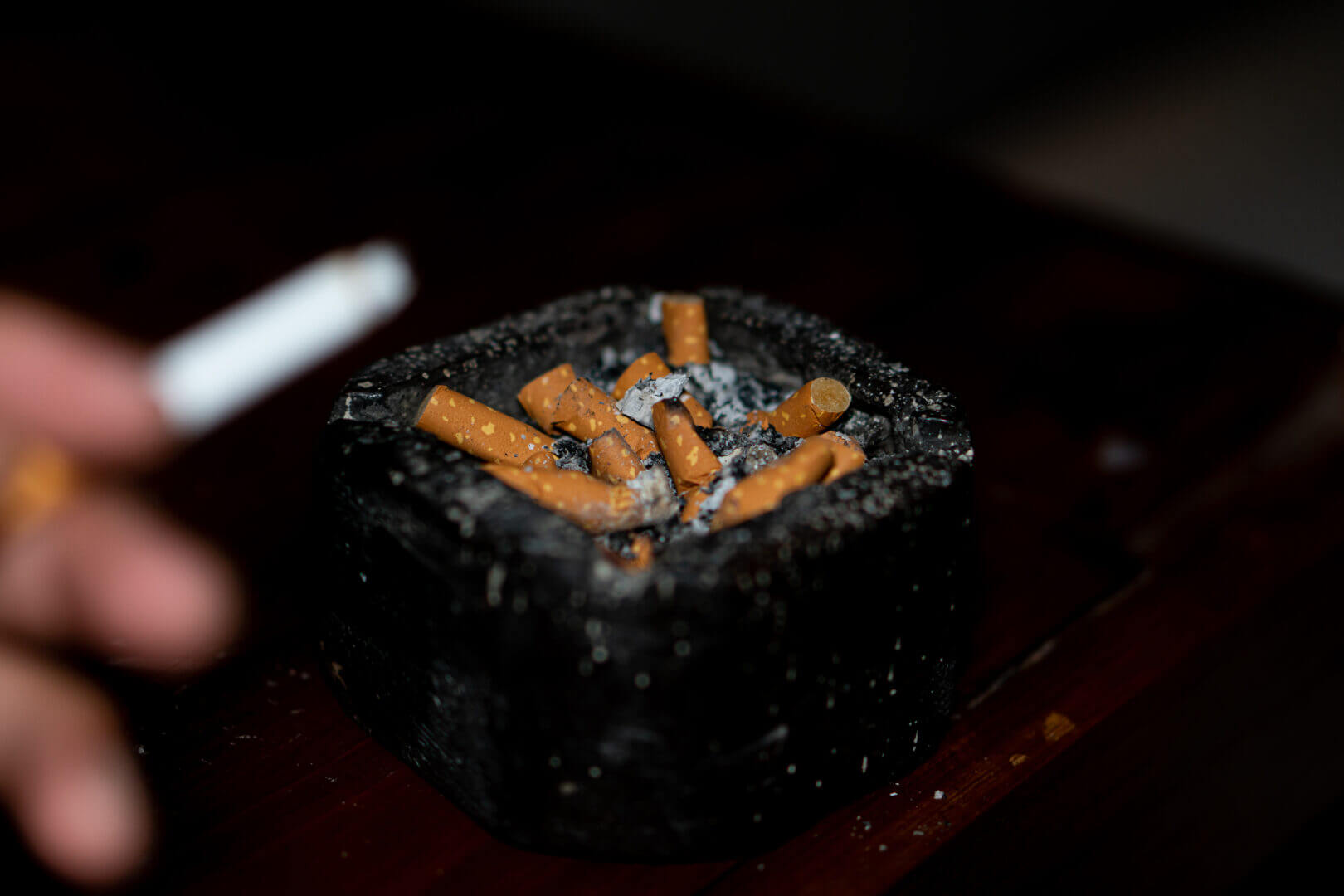 cigarette in astray on black background
