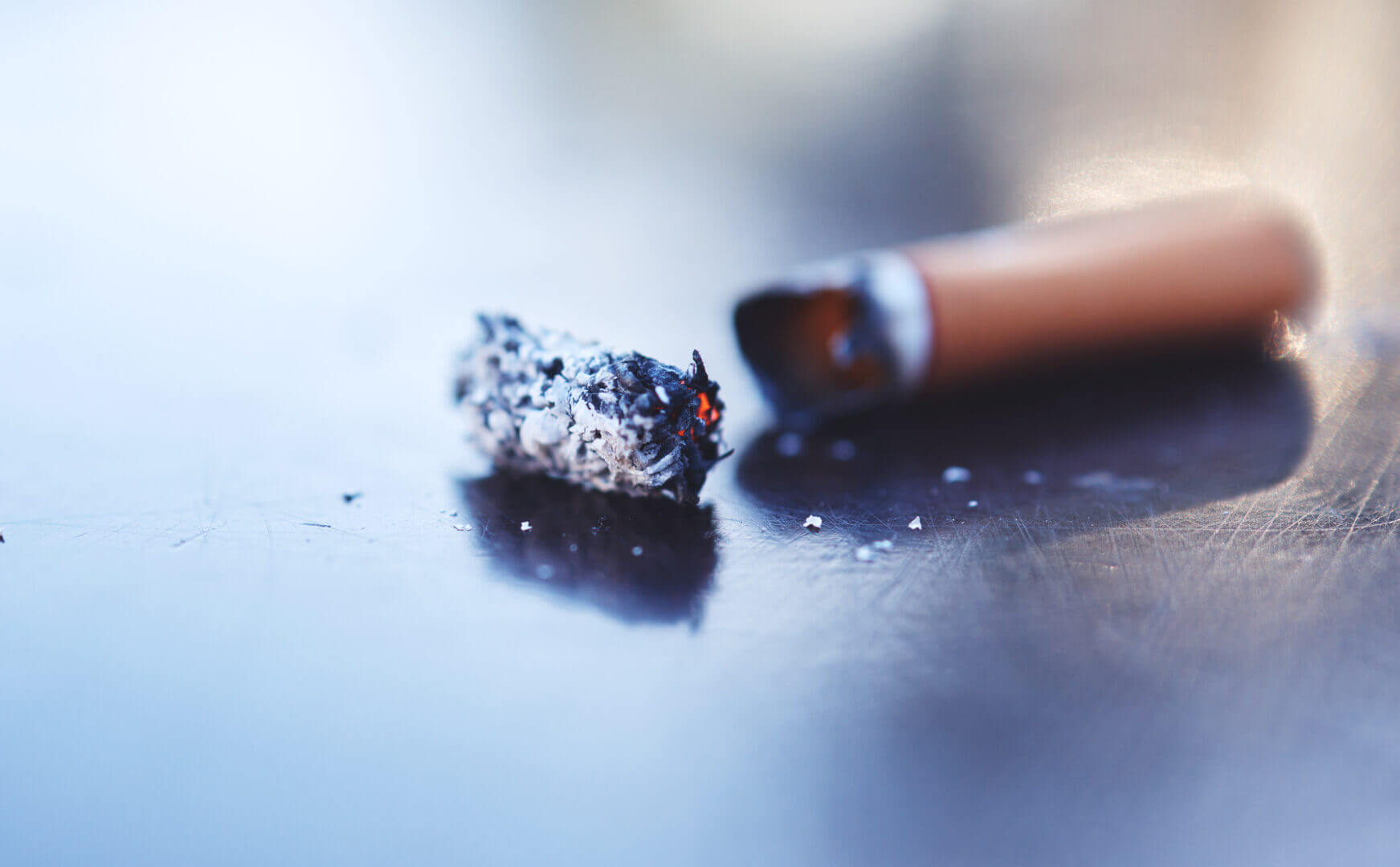 smoke ash and burning cigarette butt on table to 2025 04 06 11 29 32 utc