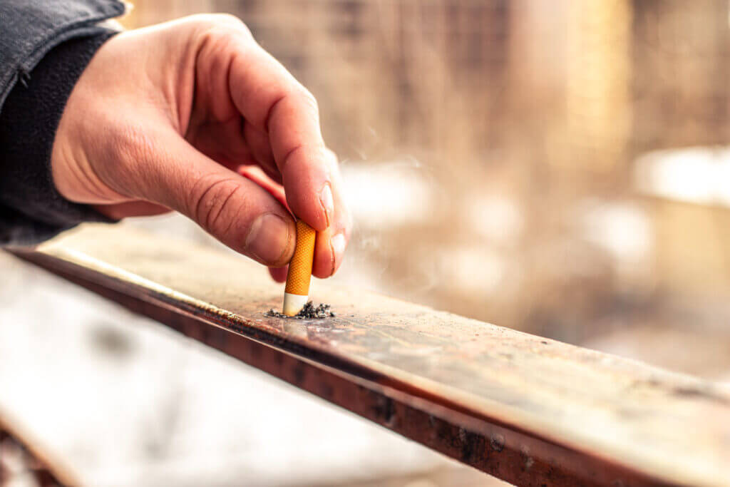 Male hands holding cigarette butt. Cigarettes. Smoking concept.