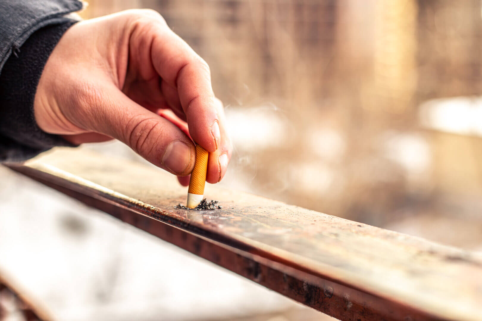 Male hands holding cigarette butt. Cigarettes. Smoking concept.